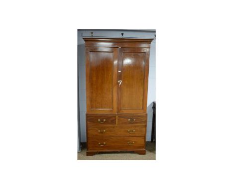 A fiddle-back and mahogany press, late 19th/early 20th Century, with cavetto cornice above a pair of panel doors enclosing ha