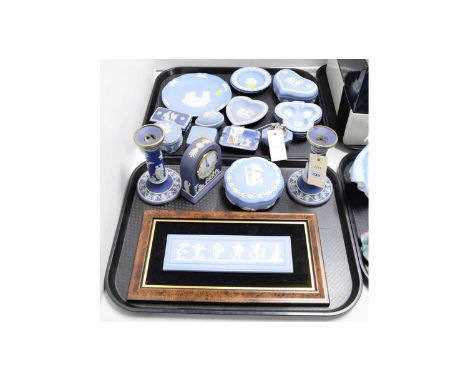 A collection of Wedgwood blue sprigged Jasperware, including: pair of candlesticks; dome cased mantel clock; framed wall plaq