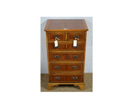 A Georgian-style yew wood veneered chest, the rectangular top above two short and three long drawers, on bracket feet, modern