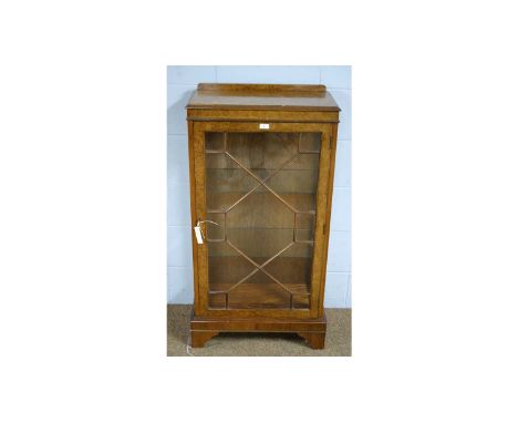 A mid 20th Century walnut low display cabinet, with single glazed astragal doors enclosing glass shelves, bracket feet, 58 x 