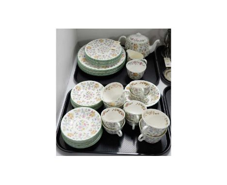 A Minton ‘Haddon Hall’ pattern dinner and tea service, including six dinner plates, eight side plates, eleven saucers, tea po