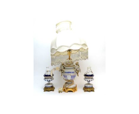 An Italian Tiche three-piece lamp garniture, the central urn form table lamp with figural twin handles, blue and gilt decorat