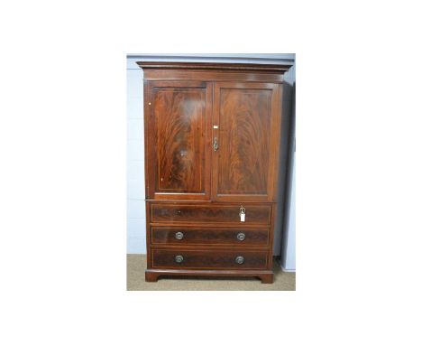 An Edwardian mahogany and satinwood banded press, with cavetto cornice above a pair of panel doors enclosing hanging space, t