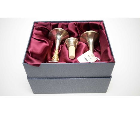 A pair of silver and silver gilt candlesticks, by Nicholas Plummer, London 2000, boxed; together with a silver mounted bottle
