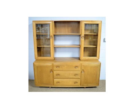 Ercol: a Windsor elm sideboard and display cabinet, the superstructure with central open shelf flanked by cupboards with glaz