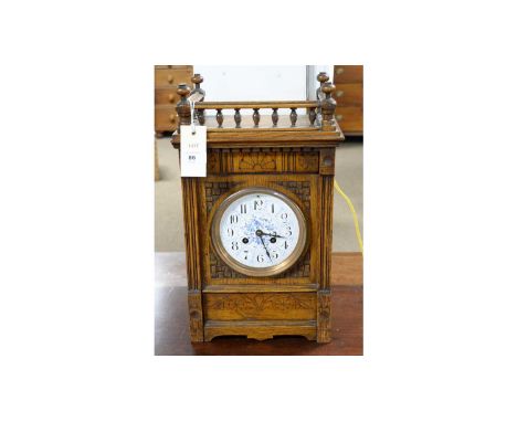 A late 19th Century carved oak mantel clock in the Aesthetic taste, with arabic dial and two-train French movement, cant whee