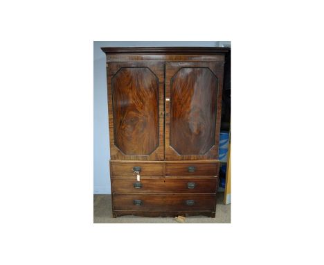 A Georgian mahogany clothes press, with cavetto cornice, above a pair of panel doors opening to reveal sliding trays, the low