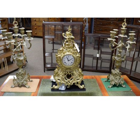An ornate Continental cast brass and Sevres style three-piece clock garniture, in the 19th Century French-style, by Lancini, 