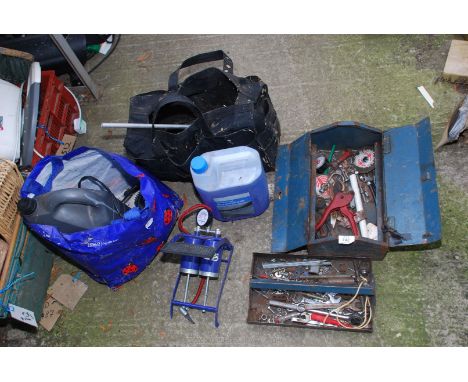 A metal tool box, various tools, foot pump, screen wash etc