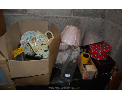 A box of miscellaneous china, lamp shades, tins, display stand etc.