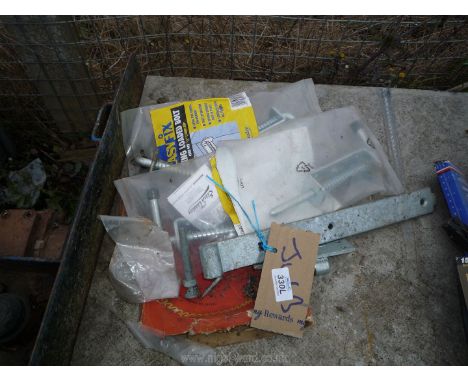 Gate hinges and bolts and a circular saw blade.
