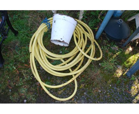 Enamel bucket and a hose.