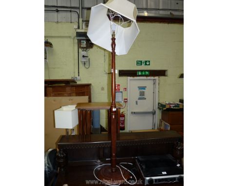 A turned wood standard lamp and shade.