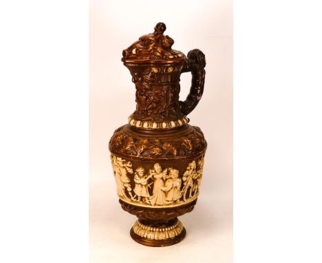 Ceramic lidded Jug with revelry scenes to body and Boar's Head to Lid - filial missing from lid - 48cm tall 