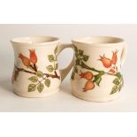A pair of Moorcroft Rosehip patterned mugs,