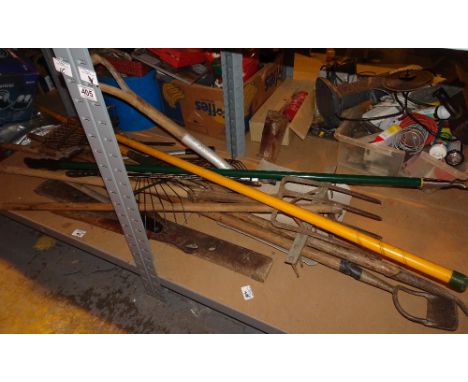 Selection of gardening tools including rakes, hoe, pruners etc