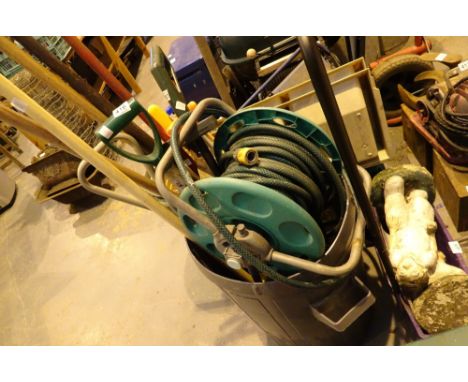 Mixed tools and a garden hose reel 