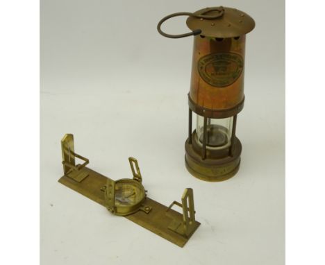 E. Thomas & Williams Ltd copper and brass miners lamp and a surveyor's type compass (2)   Condition Report   Click here for f
