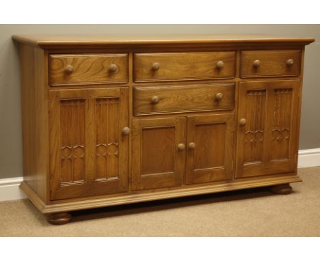 Ercol golden dawn finish sideboard with four drawers and four cupboards, W155cm, H89cm, D52cm   Condition Report   Click here