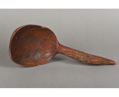 A 19th century Scandinavian carved treen ladle
The hooked handle with scrolling foliate carving.  35 cm long.  CONDITION REPO
