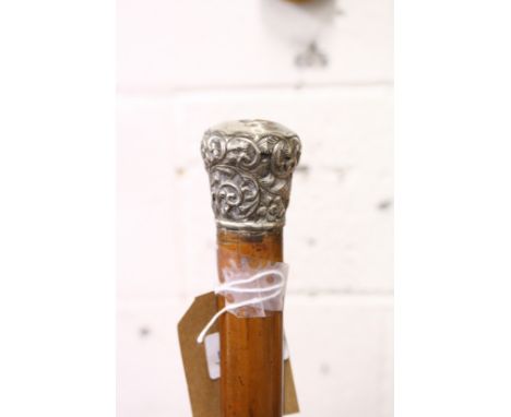 A Malacca walking stick with silver top.