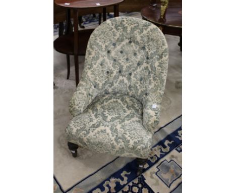 A Victorian small button upholstered armchair.