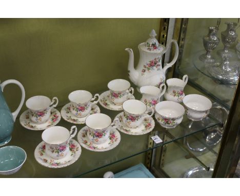 A Royal Albert Moss Rose coffee service comprising six cups and saucers, coffee pot, two milk jugs and two sugar bowls.