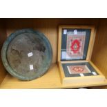 An eastern metal tray and two framed miniature Persian rugs.