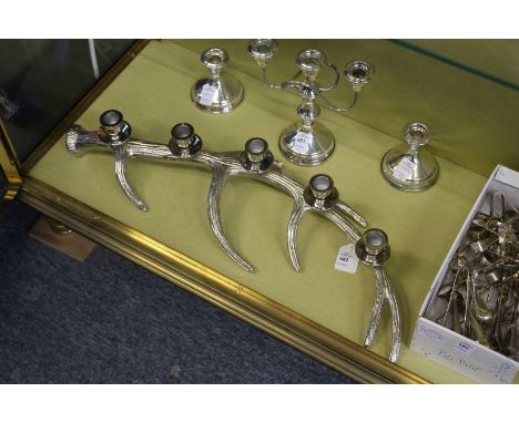 A decorative antler shaped plated candelabra.