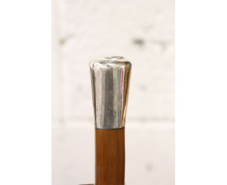 A Malacca walking stick with silver top.