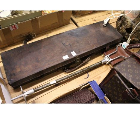 A gun case and a shooting stick.
