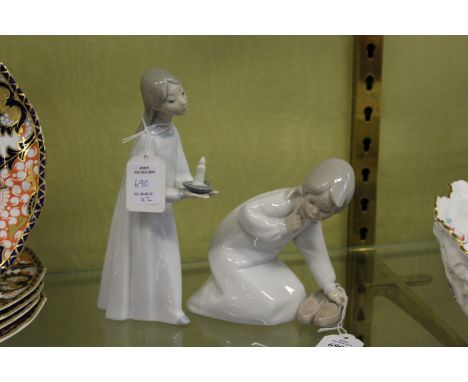 Two small Lladro figures depicting a young girl with a pair of slippers and a young girl holding a chamber stick.