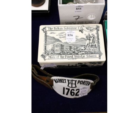A Balkan Sobranie porcelain cigarette box and cover together with a Market Porter's enamel arm badge.