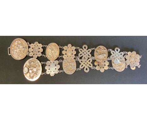 A Chinese silver belt, dragon disc buckle, floral and character panel links, 64cm long, largest panel 56mm high, 148.3g gross