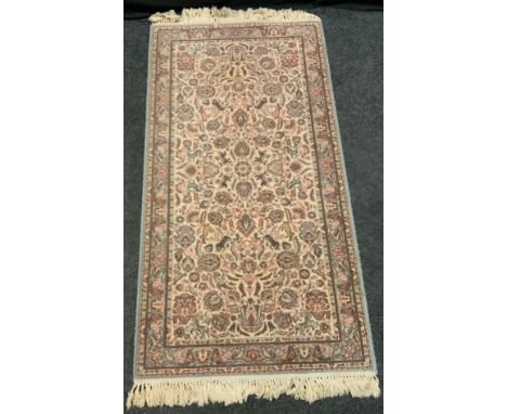 A Kirman-Shah woollen rug, in light tones of blue and pink, 83cm x 160cm 