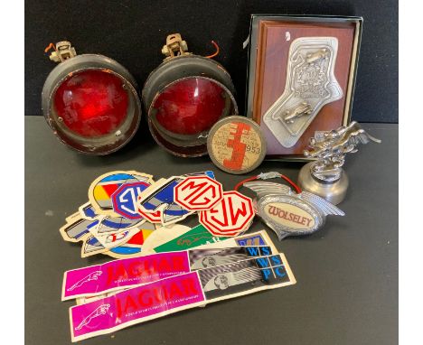 Automobilia - a vintage Griffin Car mascot;  Wolseley badge light;  Jaguar, Mini, MG and other stickers, 1953 tax disc etc. 