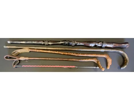 A Carved Tribal dark wood walking stick, bearded figure;  silver mounted stick;  riding crop etc. 