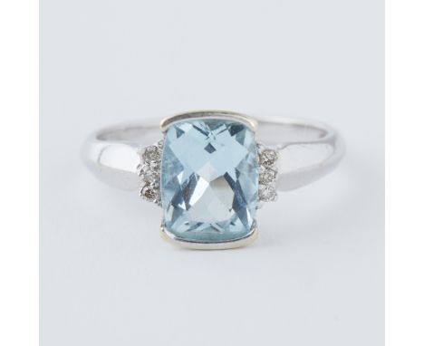A 9ct white gold ring set with a rectangular cut blue topaz, approx. 2.60 carats, with three small round brilliant cut diamon