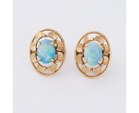 A pair of yellow gold (not hallmarked or tested) oval 'flower' style earrings set with a central oval cabochon cut opal, the 