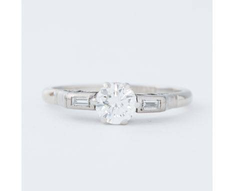 A platinum Art Deco ring set with a central round brilliant cut diamond, approx. 0.68 carats, approx. colour H-I and VS2-SI1 