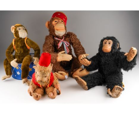 A collection of four vintage monkey toys, including two of Schuco type and converted to battery power automaton, one seated o