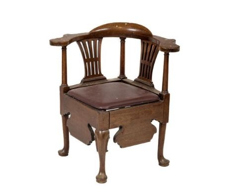 A George III walnut Corner Armchair, with shaped flat arm rests and above two pierced splats and turned posts above a later s