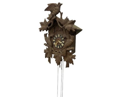 A late 19th Century Swiss oak framed Hanging Cuckoo Clock, with carved bird and leaf decoration, with circular dial and Roman
