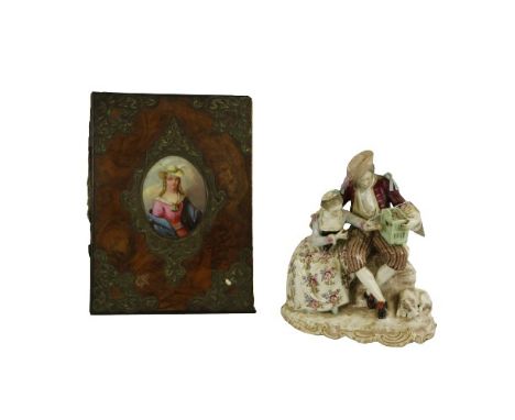 A Samson porcelain Group, modelled with elegant couple seated holding a bird and cage, 24cms (91/2") together with a brass mo