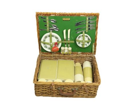 A Sirram Picnic Set, comprising flasks, containers, plates, cutlery etc., housed in a cane work basket. (1) 