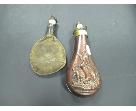 An Early 20th Century Sporting Copper and Brass Powder Flask, with inlaid hunting scenes; together with a canvas shot flask. 