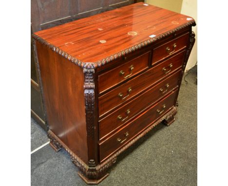 A reproduction mahogany chest of drawers two short cock beaded drawers over three long profusely moulded throughout shaped br