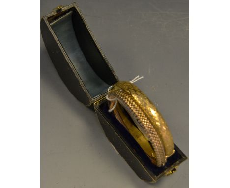 A 9ct gold bangle, foliate scrolling 9.8g; another gold coloured (2)