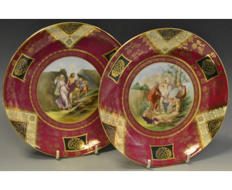 A pair of Vienna circular plates,  painted to centre with Biblical scenes, gilded border on a ruby ground, 18.5cm diam, shiel