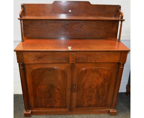 A Victorian flame mahogany and oak chiffonier, shaped super structure with one long shelf, turned pilaster supports, projecti